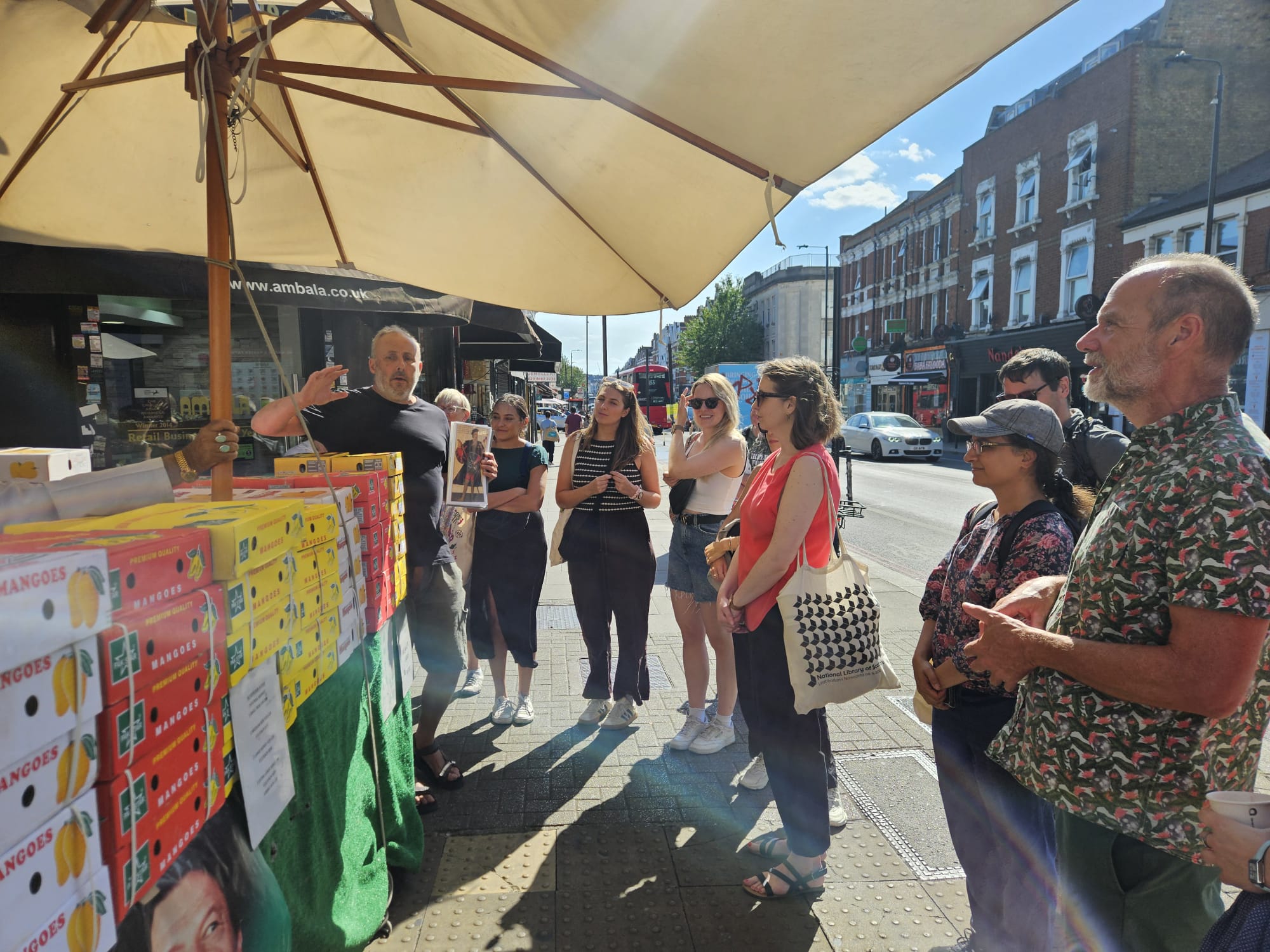A food heritage walk beside mango boxes on a Tooting street